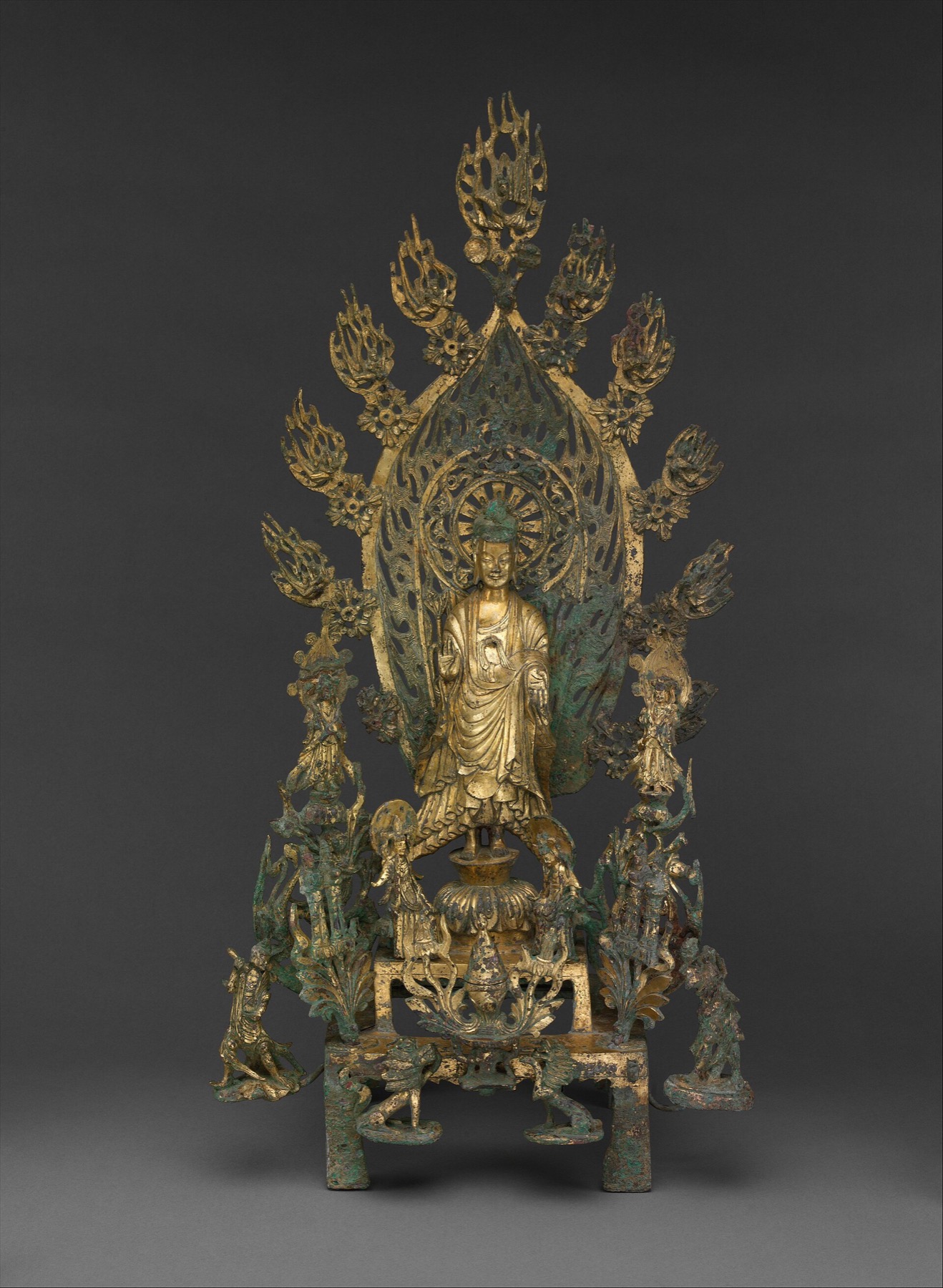 北魏正光五年铜弥勒佛像：一整组鎏金铜像，中央立佛身后是巨大的火焰形光背，边缘伸出一簇簇火焰，周围有菩萨、供养人和香炉